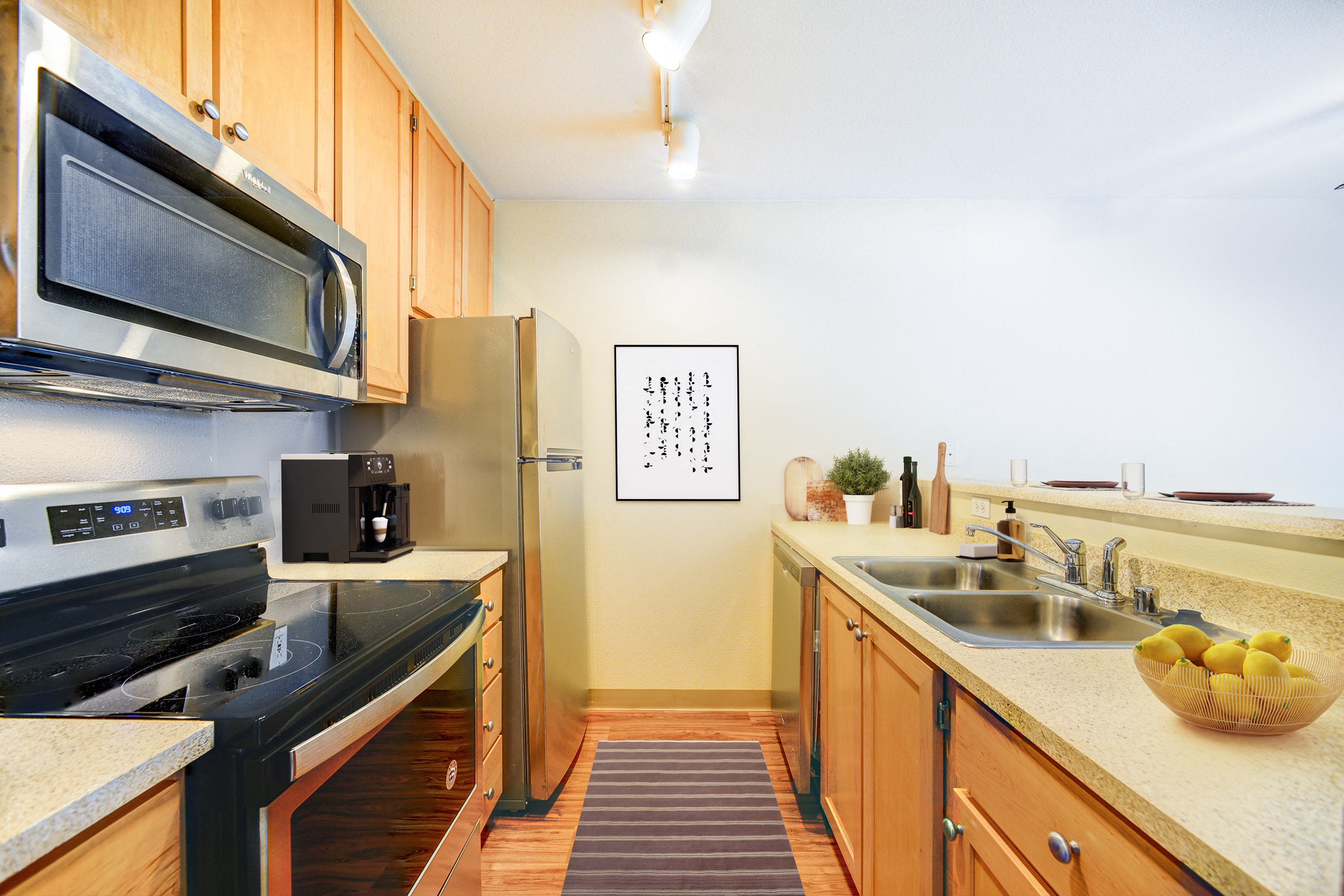 a kitchen with stainless steel appliances and wooden cabinets